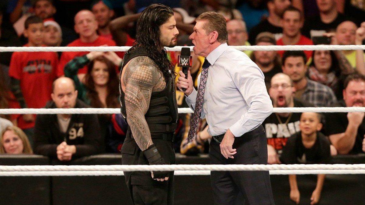 Roman Reigns squaring off with Vince McMahon