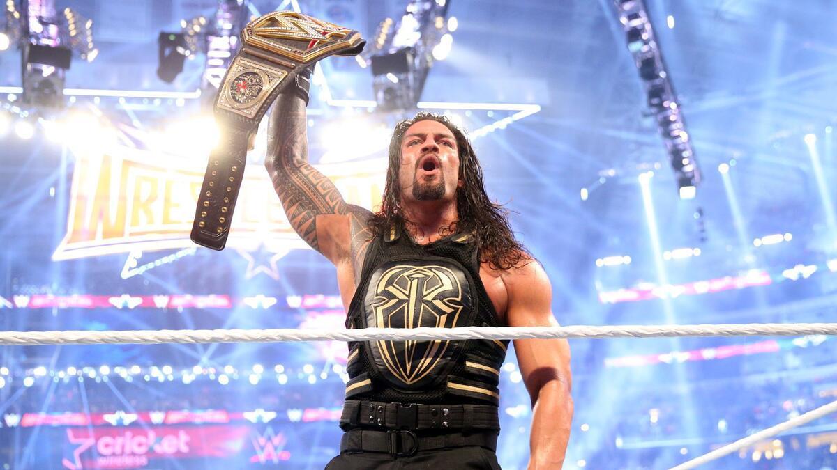 Roman Reigns holding the WWE Title at WrestleMania 32