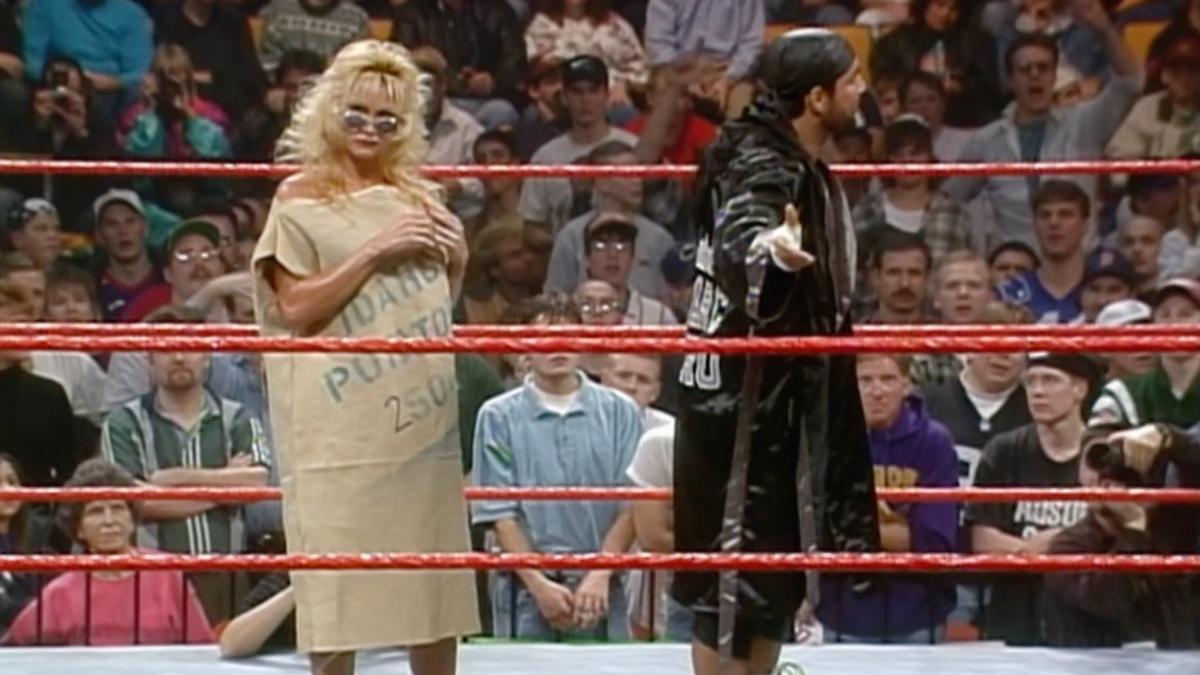 Sable wearing a potato sack while Marc Mero has his back turned