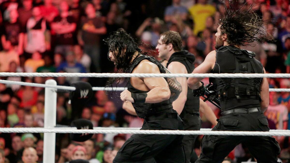 Seth Rollins hits Roman Reigns from behind with a steel chair