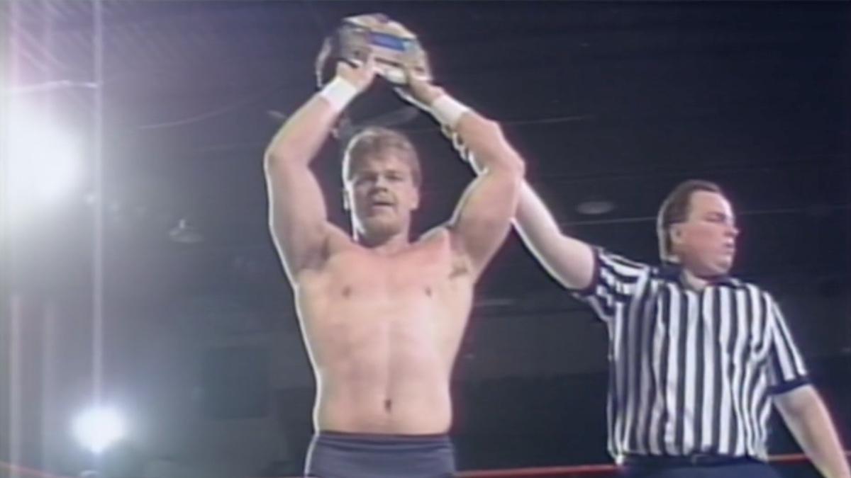 Shane Douglas holding up the ECW Title in 1994