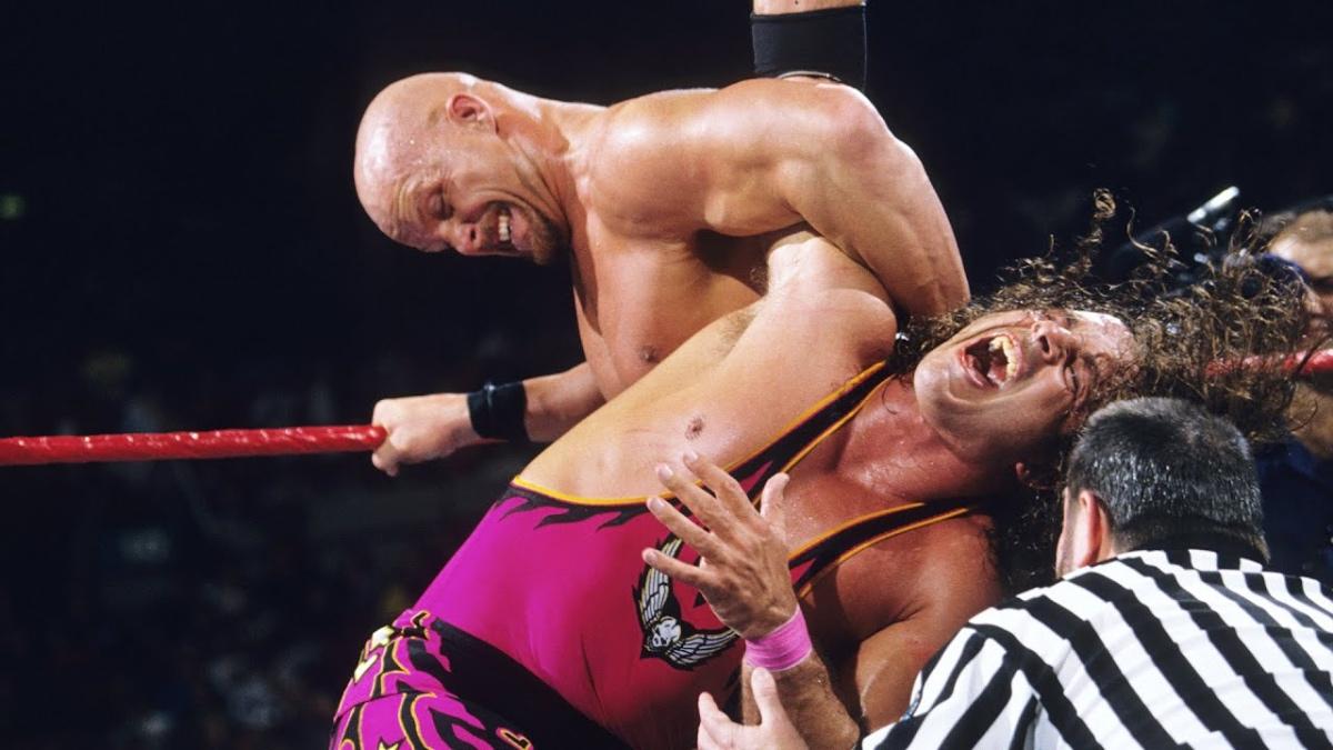 Steve Austin with an abdominal stretch on Bret Hart at WWE Survivor Series 1996