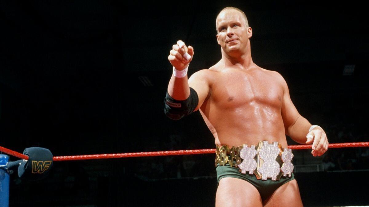 Steve Austin wearing green trunks and the Million Dollar Title