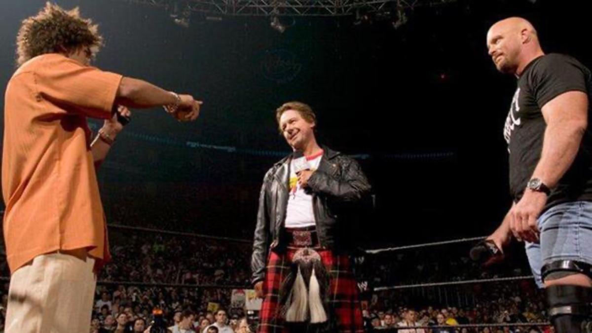 Steve Austin and Roddy Piper looking at Carlito at WrestleMania 21