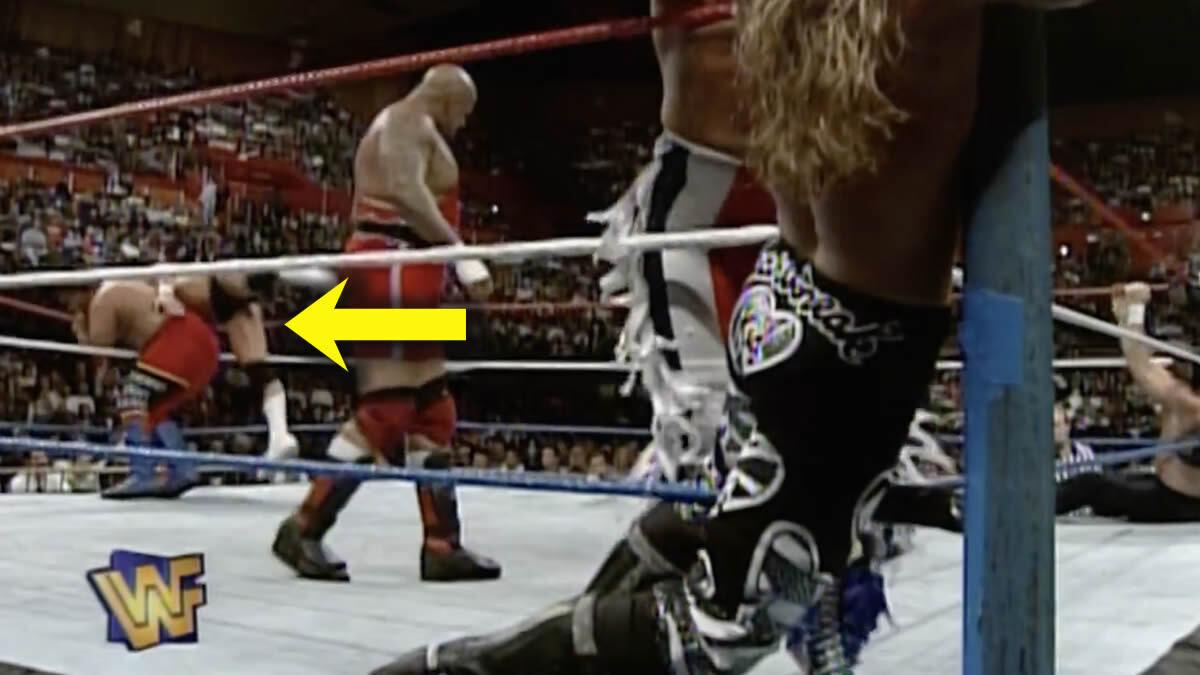 Steve Austin being knocked over the rope rope with a yellow arrow pointing to it in the 1996 Royal Rumble