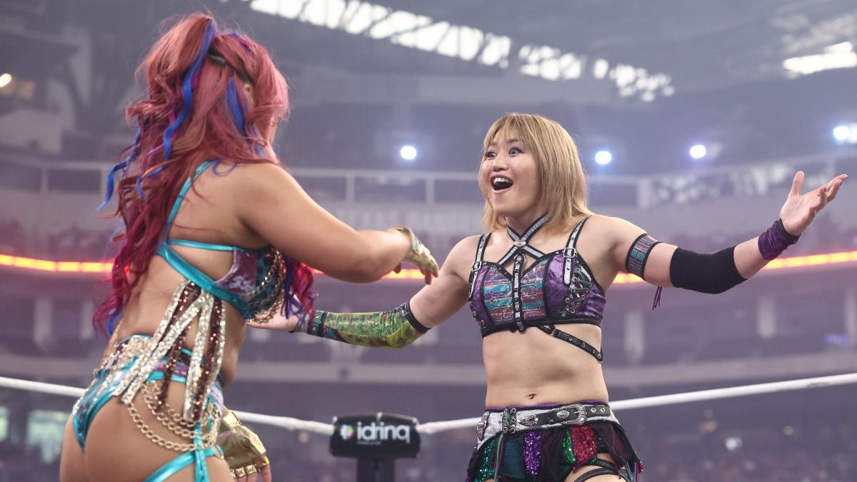 Syuri holds her arms out and smiles while facing Mina Shirakawa at AEW All In 2025