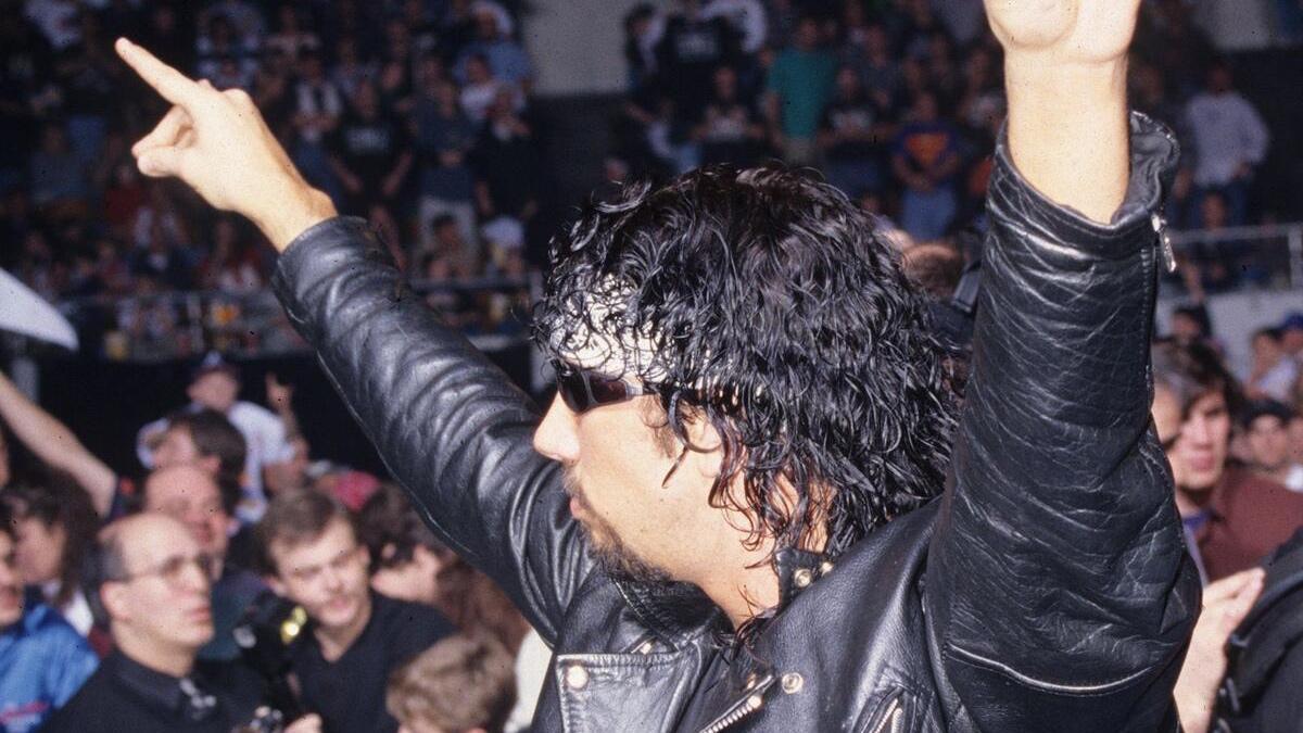 Syxx in WCW with his arms up 