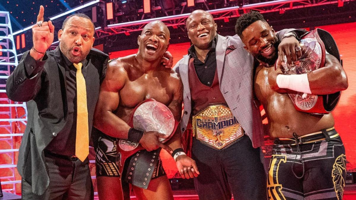The Hurt Business poses with their championship belts
