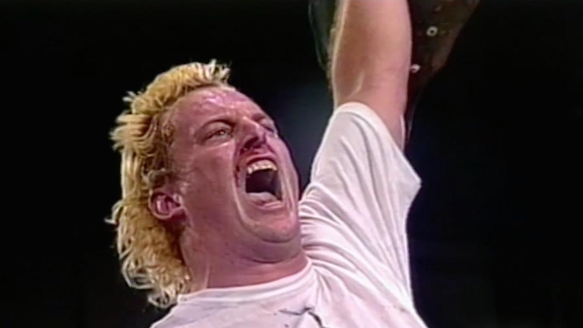 Sandman shouting and holding up the ECW World Heavyweight Title