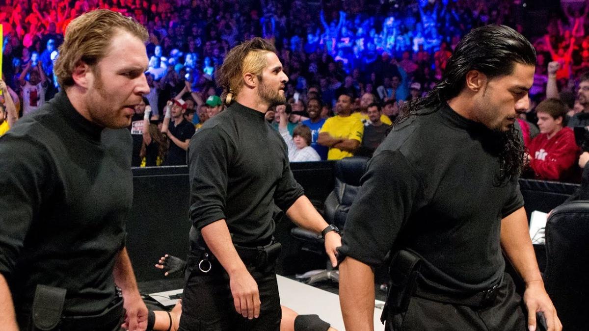 The Shield standing at ringside in black turtlenecks at WWE Survivor Series 2012