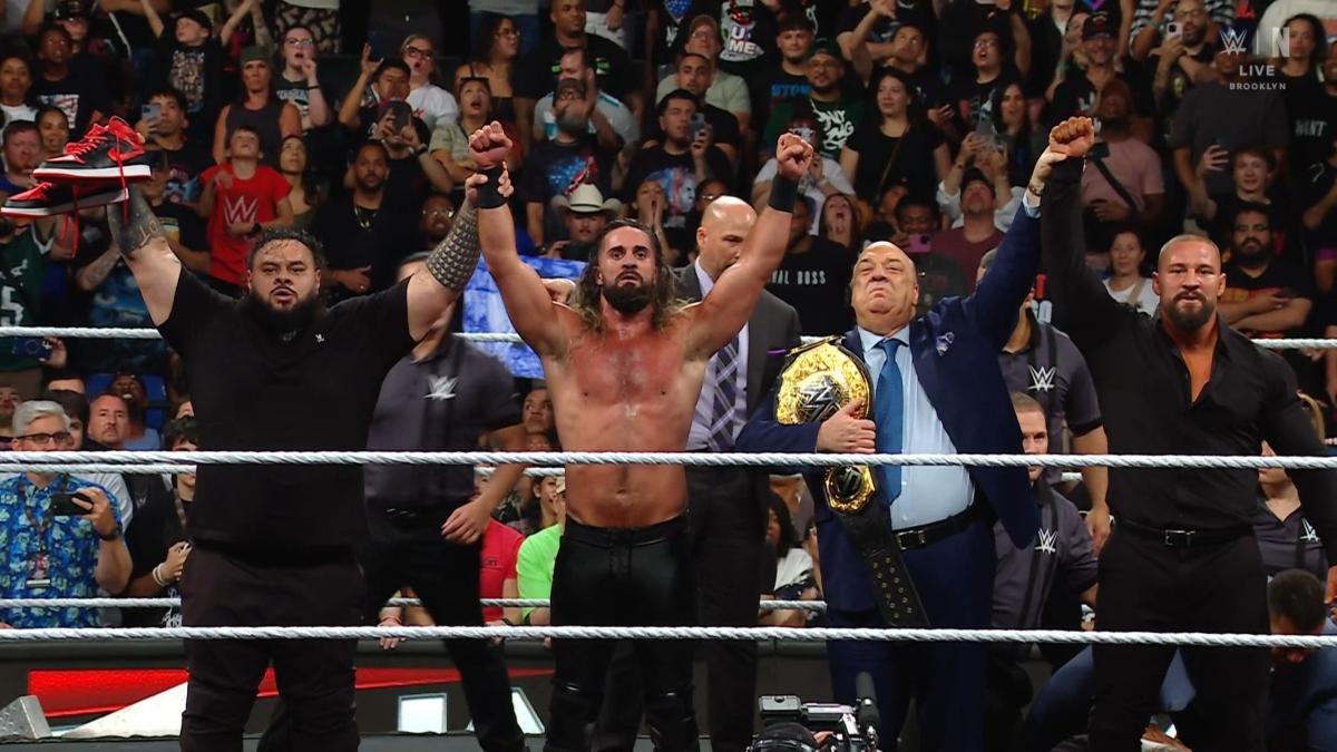 The Vision - Bronson Reed, Seth Rollins, Paul Heyman and Bron Breaker - stand with their hands raised in the middle of the ring