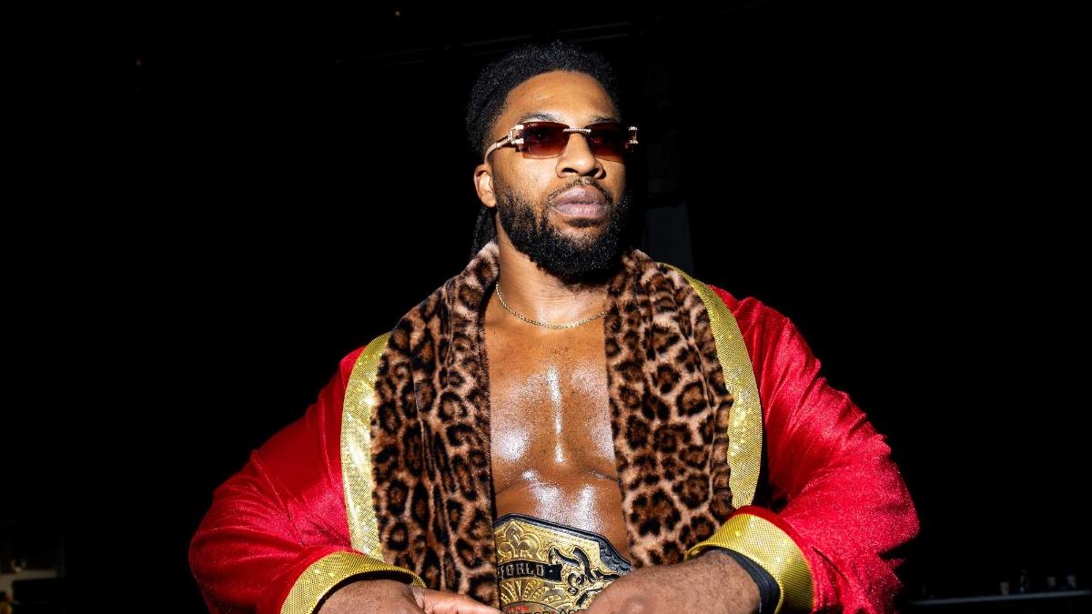 Trick Williams in a robe and leopard print scarf while backstage at TNA Slammiversary