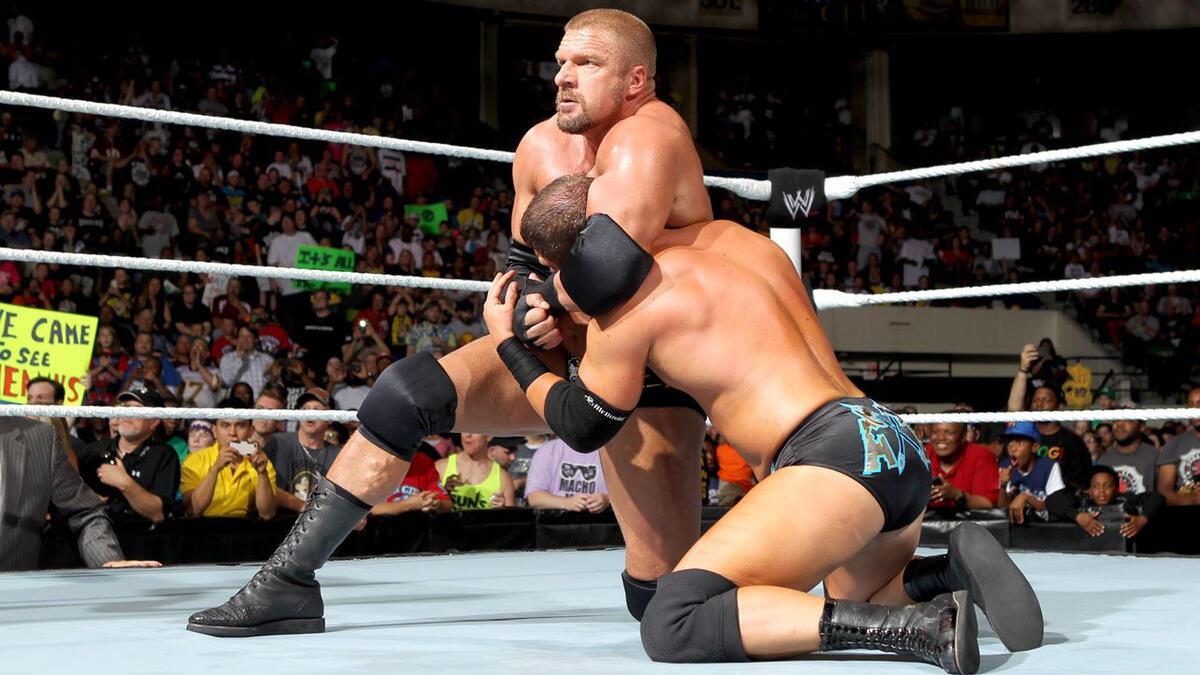 Triple H with Curtis Axel in a headlock