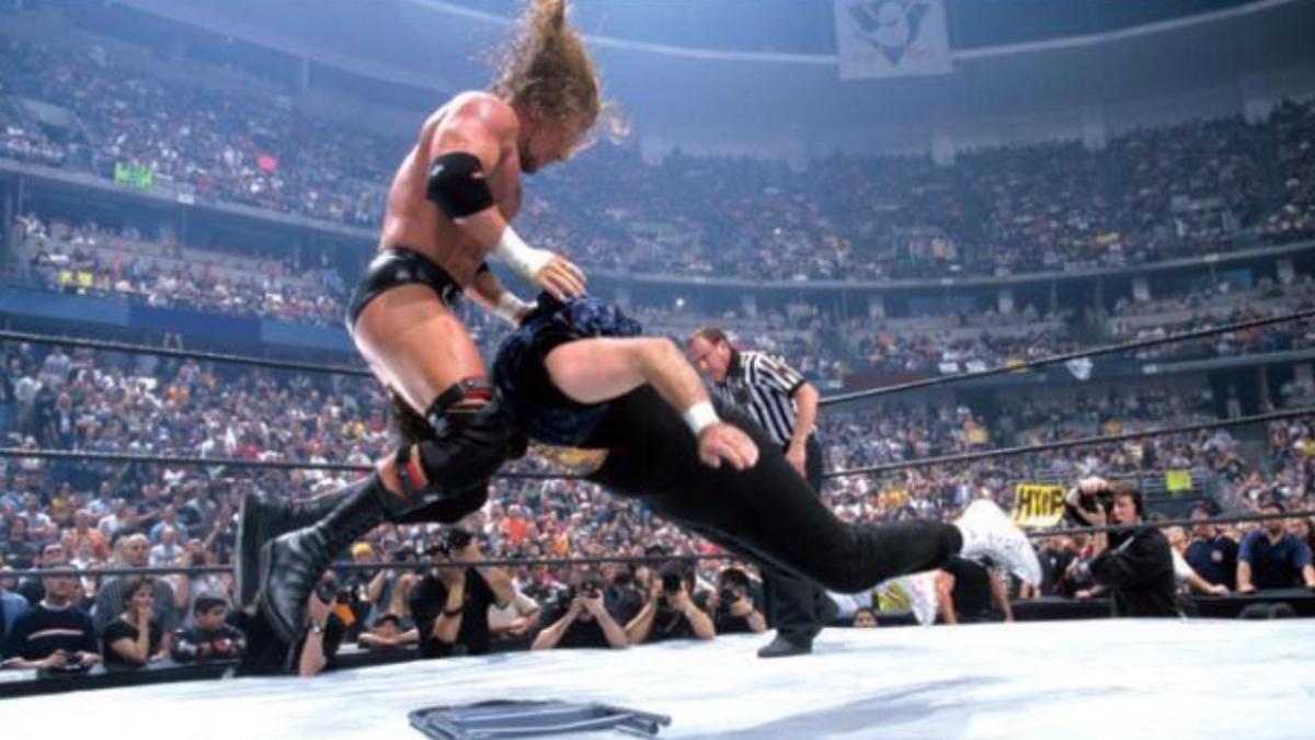Triple H hitting a pedigree to Mick Foley at WWE WrestleMania 2000
