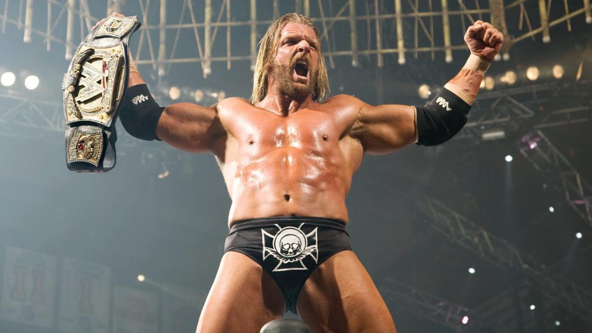 Triple H celebrating with the WWE Title at No Mercy 2007