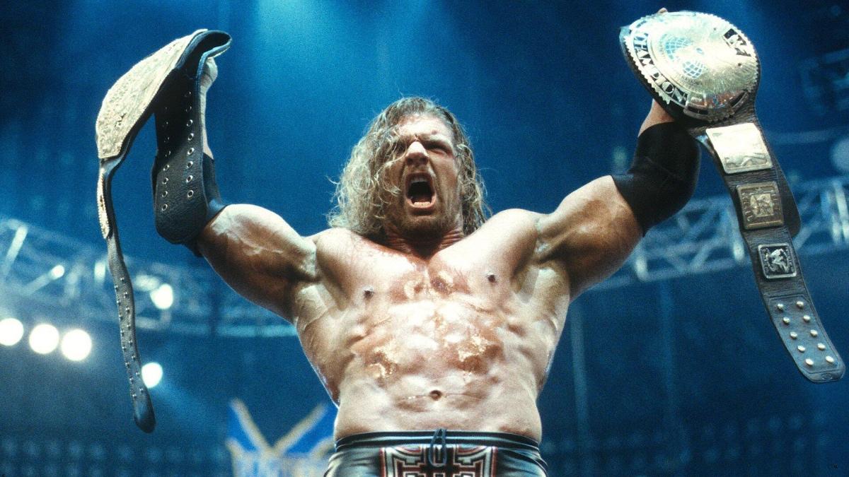 Triple H holding up the World Heavyweight Title and WWF Title at WrestleMania 18