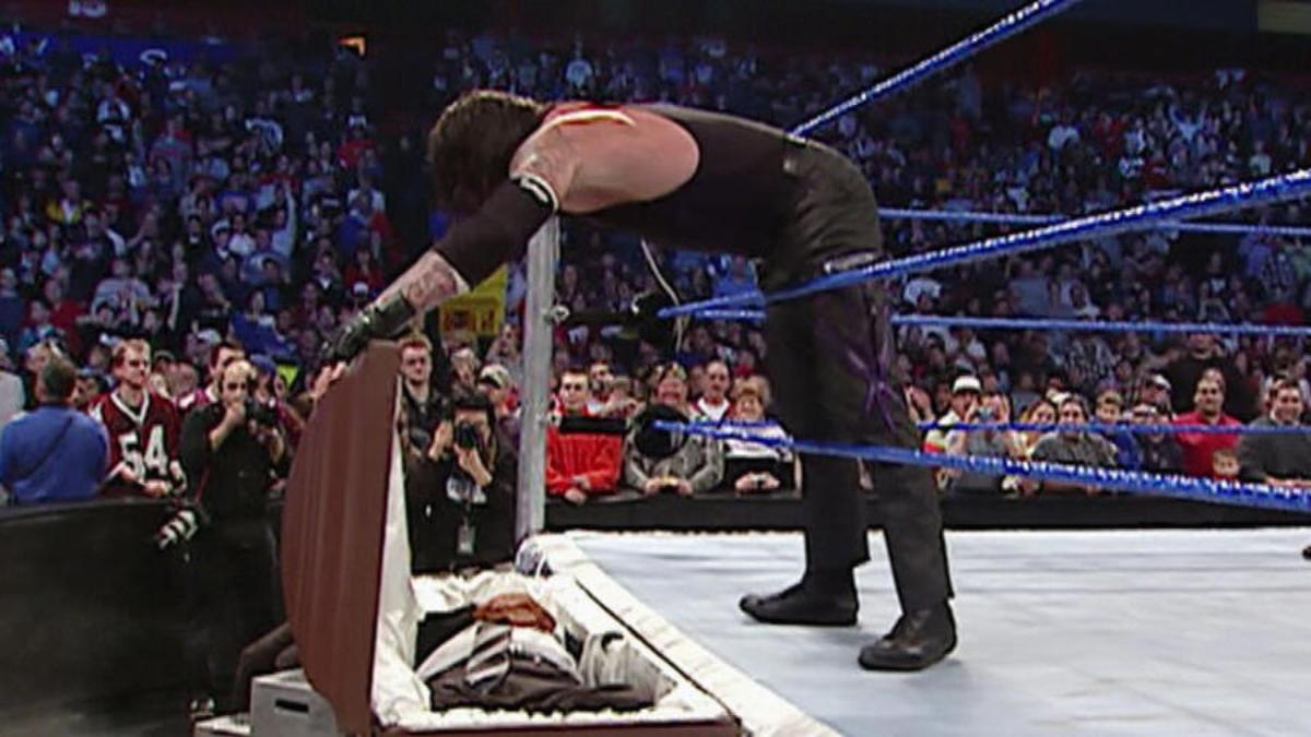 The Undertaker closing a casket on Paul Heyman