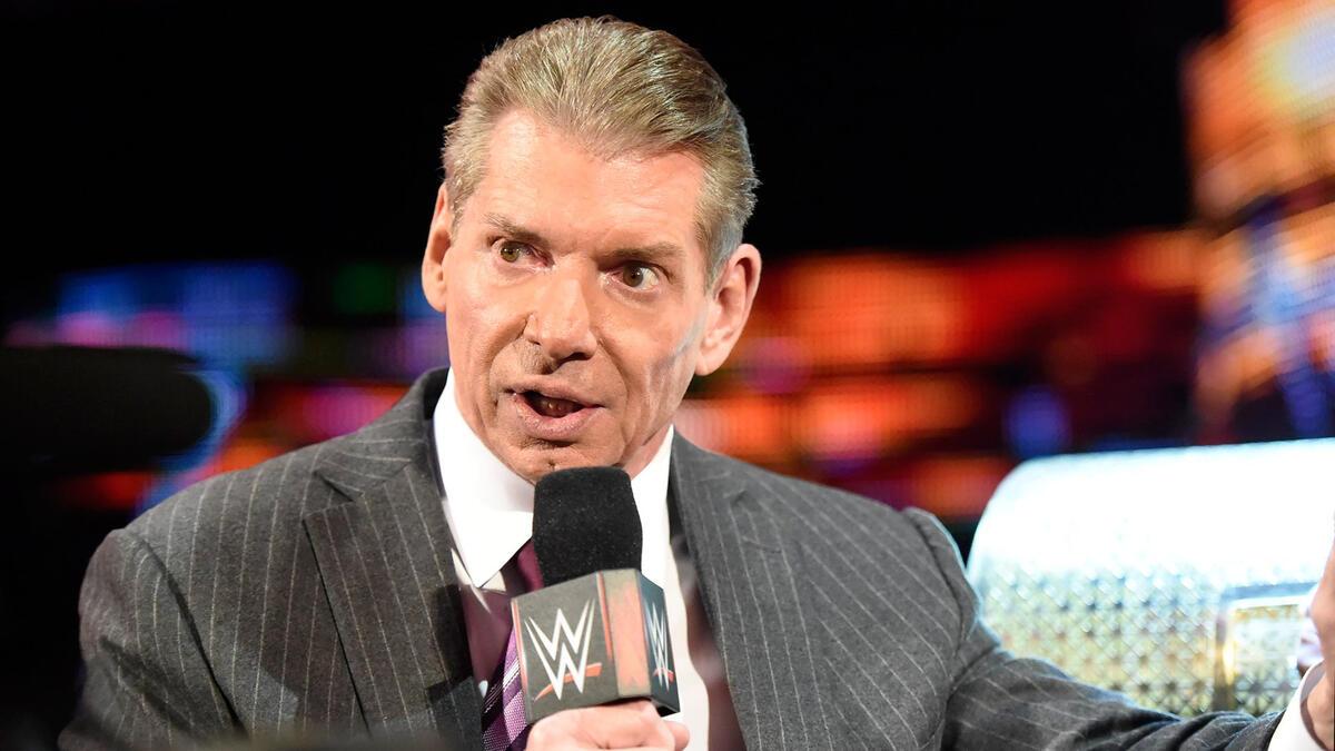 Vince McMahon holds the microphone while cutting a promo on an episode of WWE Raw in 2016