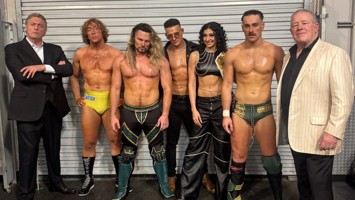 William Regal, Charlie Dempsey, Lexis King, Channing "Stacks" Lorenzo, Arianna Grace, Uriah Connors, and Fit Finlay standing backstage for a photo