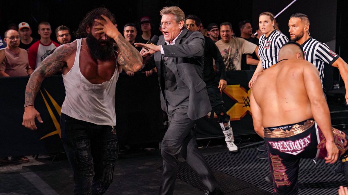 William Regal running as wrestlers brawl around him on WWE NXT