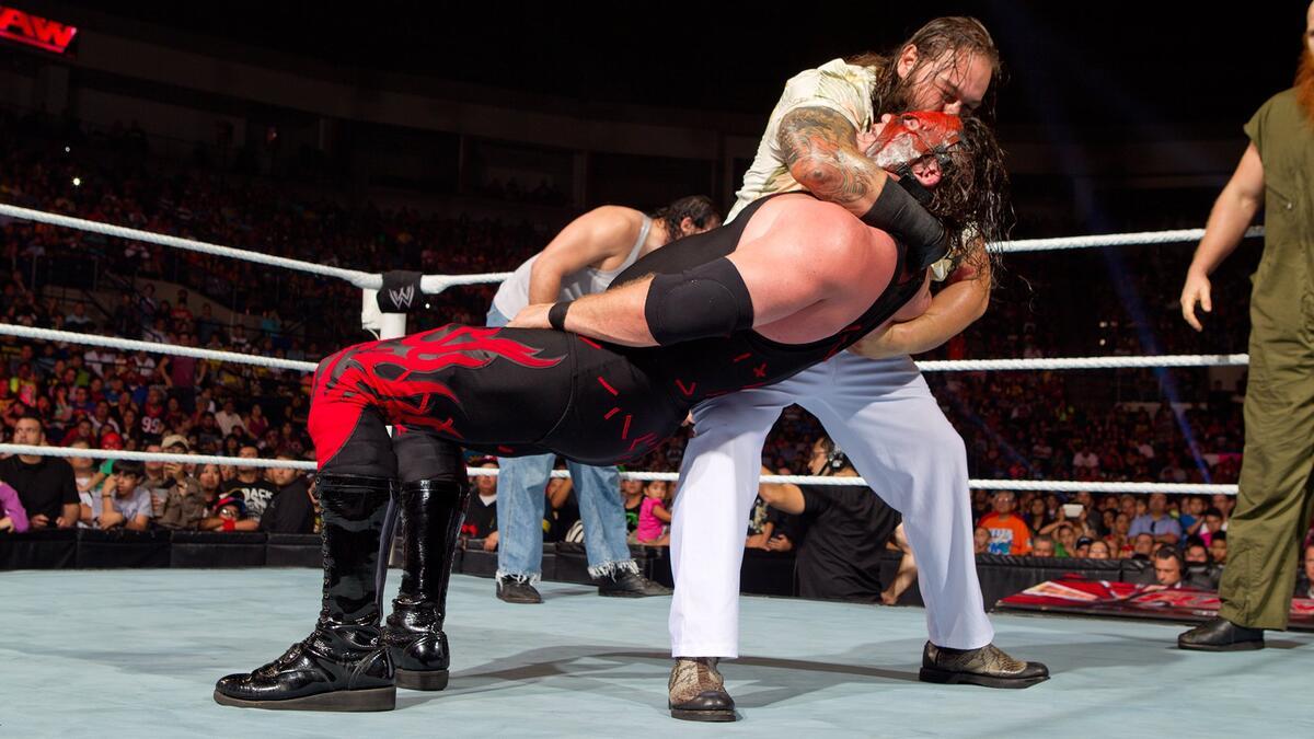 Bray Wyatt whispers to Kane before a Sister Abigail