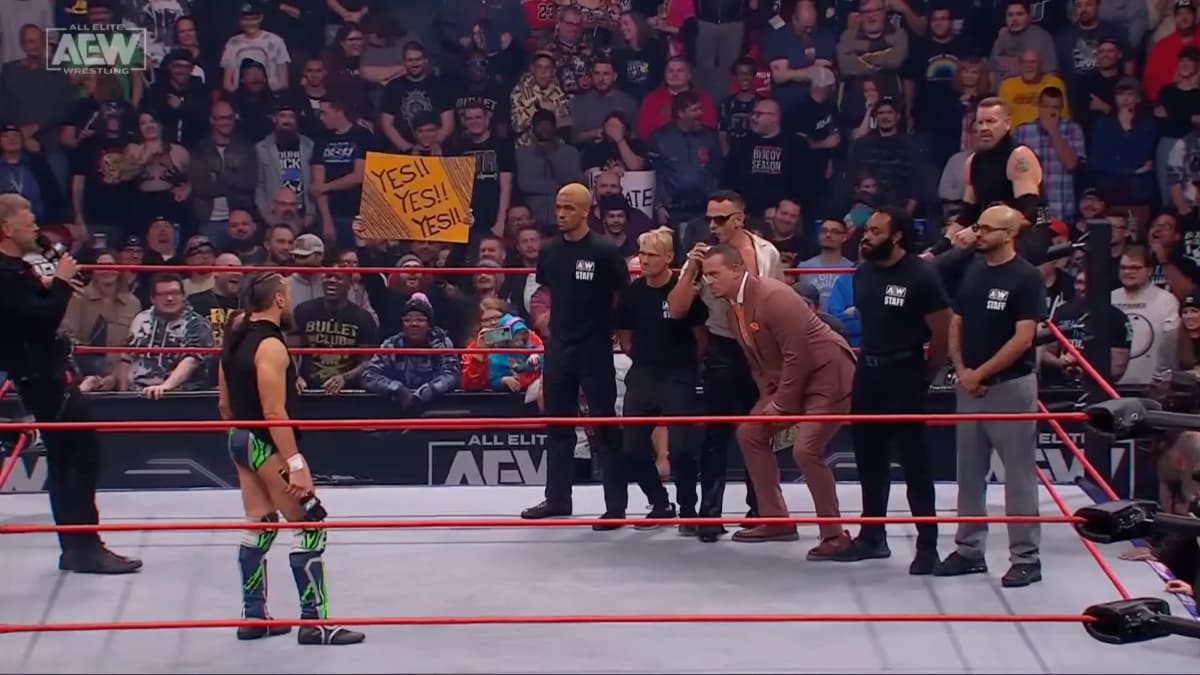 Ricky Starks, Christian Cage and a security team on the right side of the ring with Bryan Danielson and Adam Copeland stood together on the left