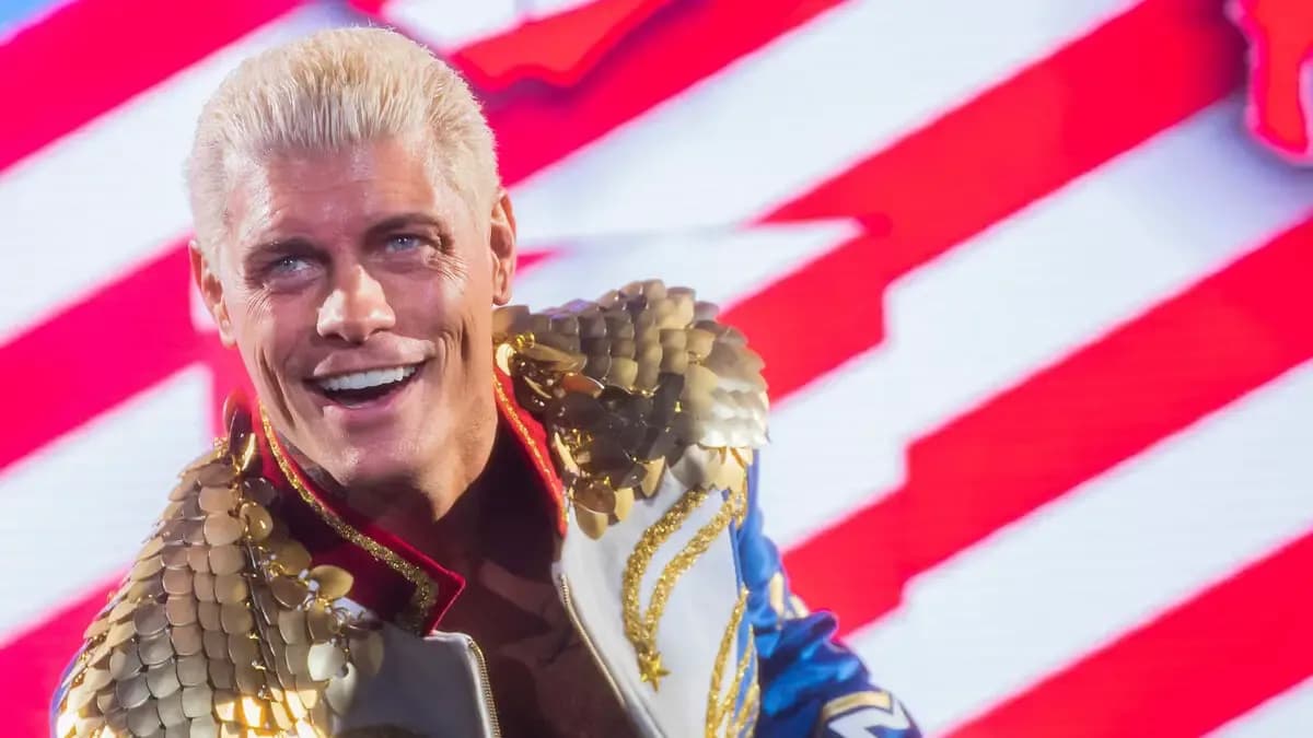 Cody Rhodes makes his entrance at a 2024 house show, with the colours of the American flag displayed prominently in the background.