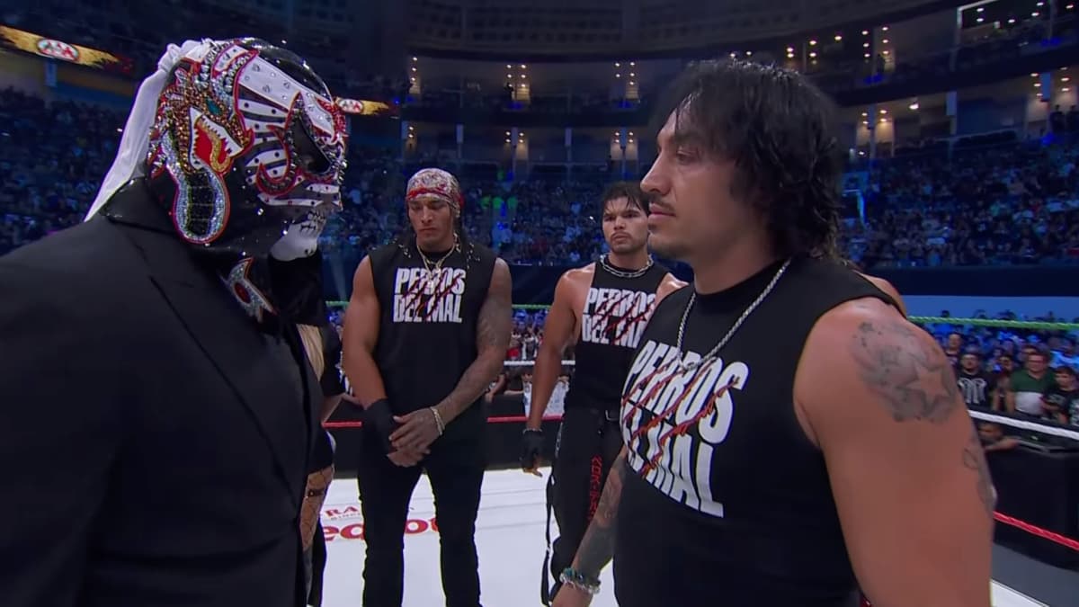 Penta staring at Daga's Los Perros Del Mal shirt