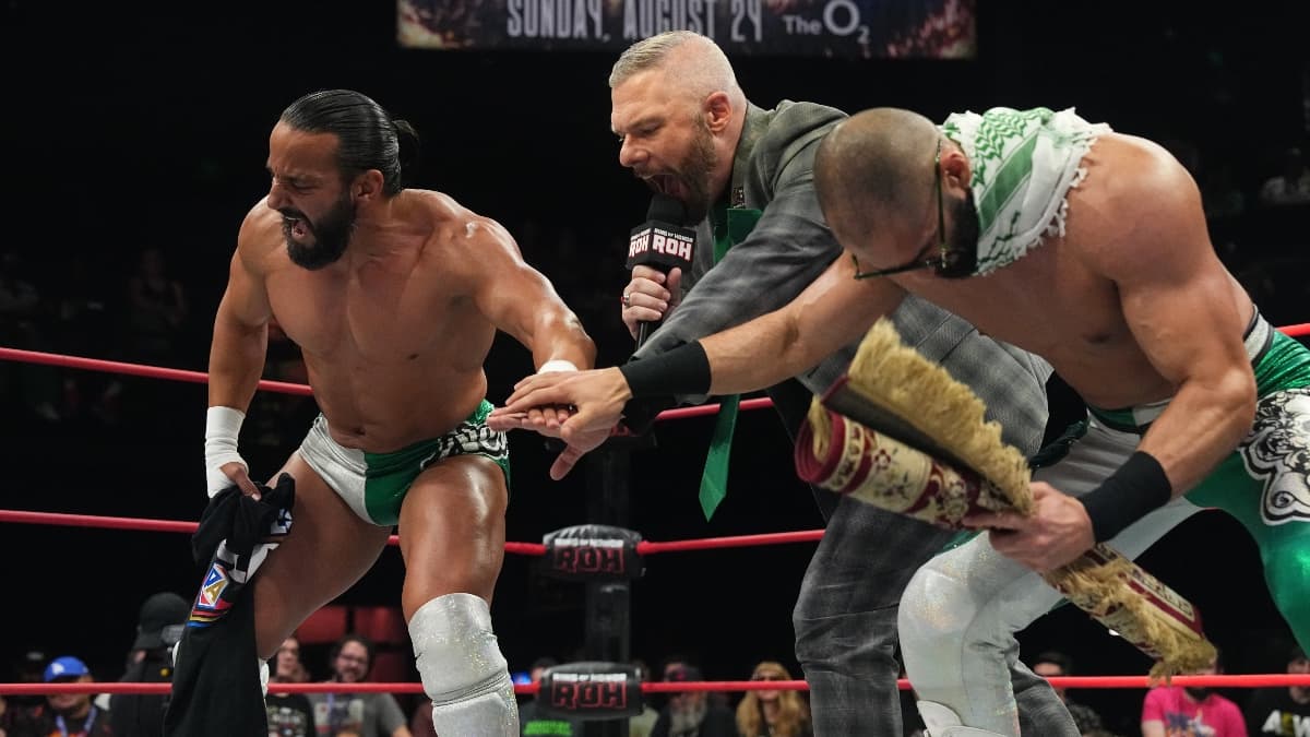 Tony Nese and Ariya Daivari touching hands at Mark Sterling introduces them