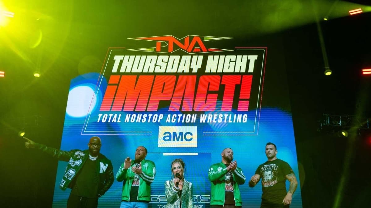 Logo for TNA Thursday Night IMPACT on AMC on a video screen with The System faction stood in front of them