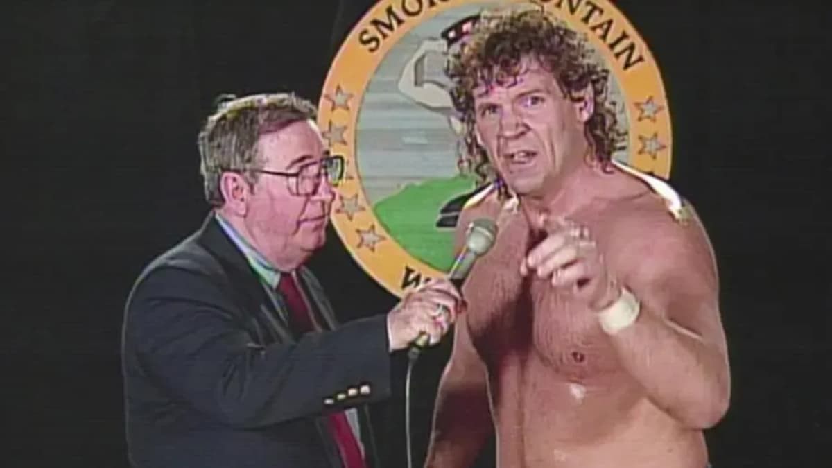 Tracy Smothers being interviewed in front of Smoky Mountain Wrestling logo