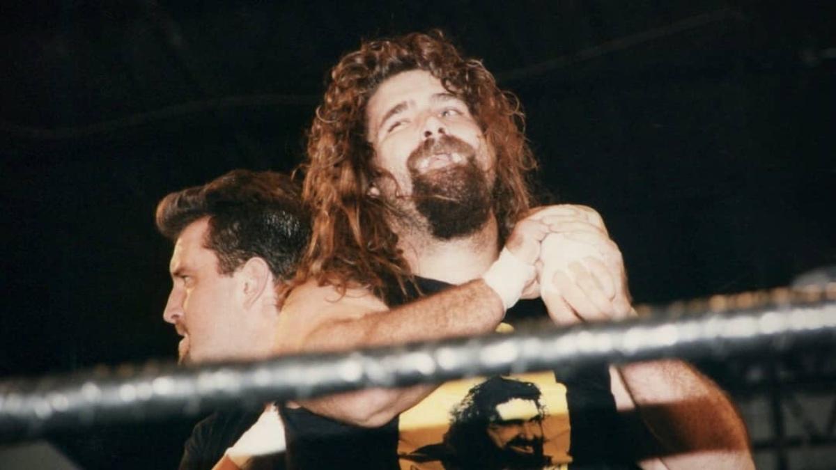 Mick Foley with a rest hold on Tommy Dreamer