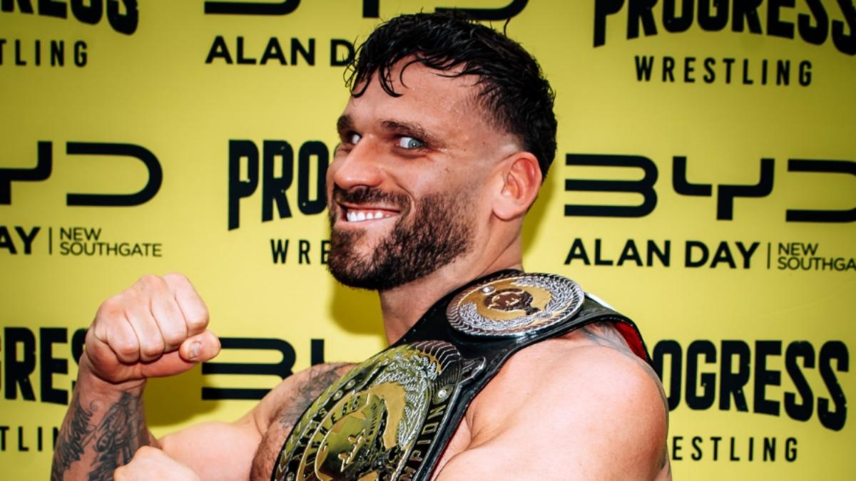 Mike D Vecchio holding the PROGRESS Atlas Title with wild eyes