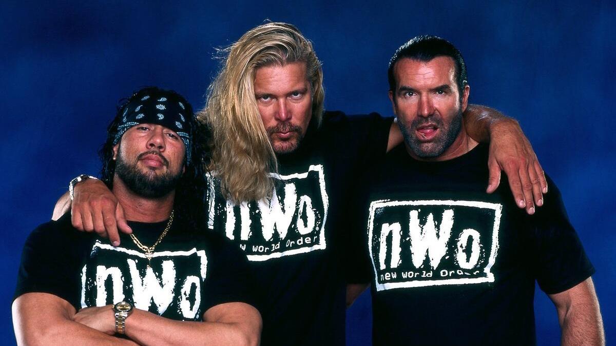 NWO in photoshoot with X-Pac on the left, Kevin Nash in the middle, and Scott Hall on the right with all men staring straight ahead