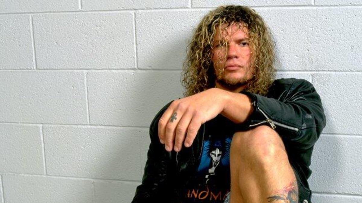 Raven sitting by a white wall