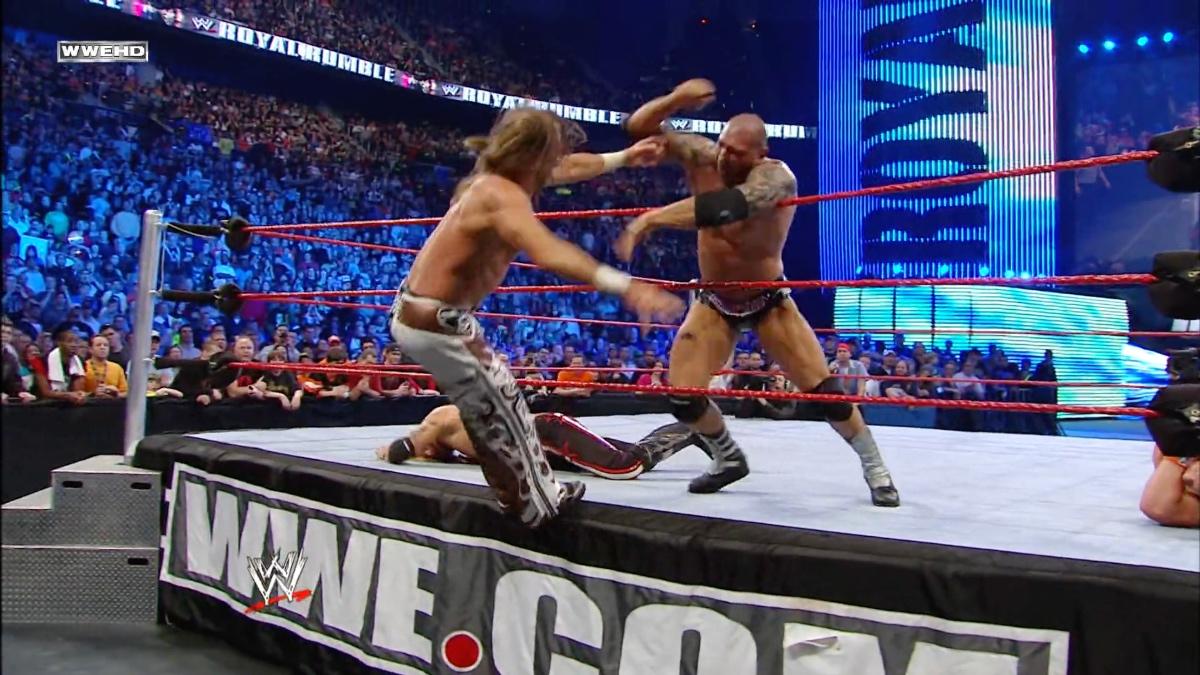 Shawn Michaels letting go of the ropes as Batista prepares a hammer first at WWE Royal Rumble 2010