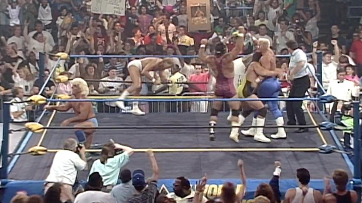 Sting celebrating his Great American Bash win with multiple babyface while Flair stands away despondent.