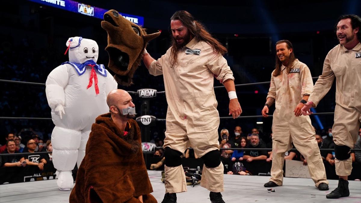 The Elite dressed as Ghostbusters with the Stay Puft Marshmallow Man behind them and Brandon Cutler in pain dressed as a horse on his knees