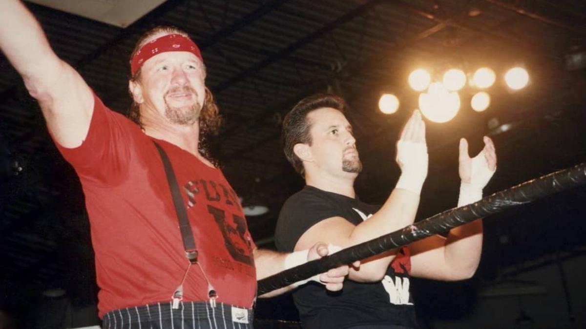 Terry Funk standing alongside Tommy Dreamer, who is clapping