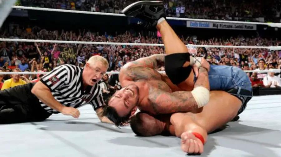 https://cultaholic.com/files/images/7114ab580983a7f393fe2f43c7a06616163c8b65-cm-punk-john-cena-money-in-the-bank-2011.jpg
