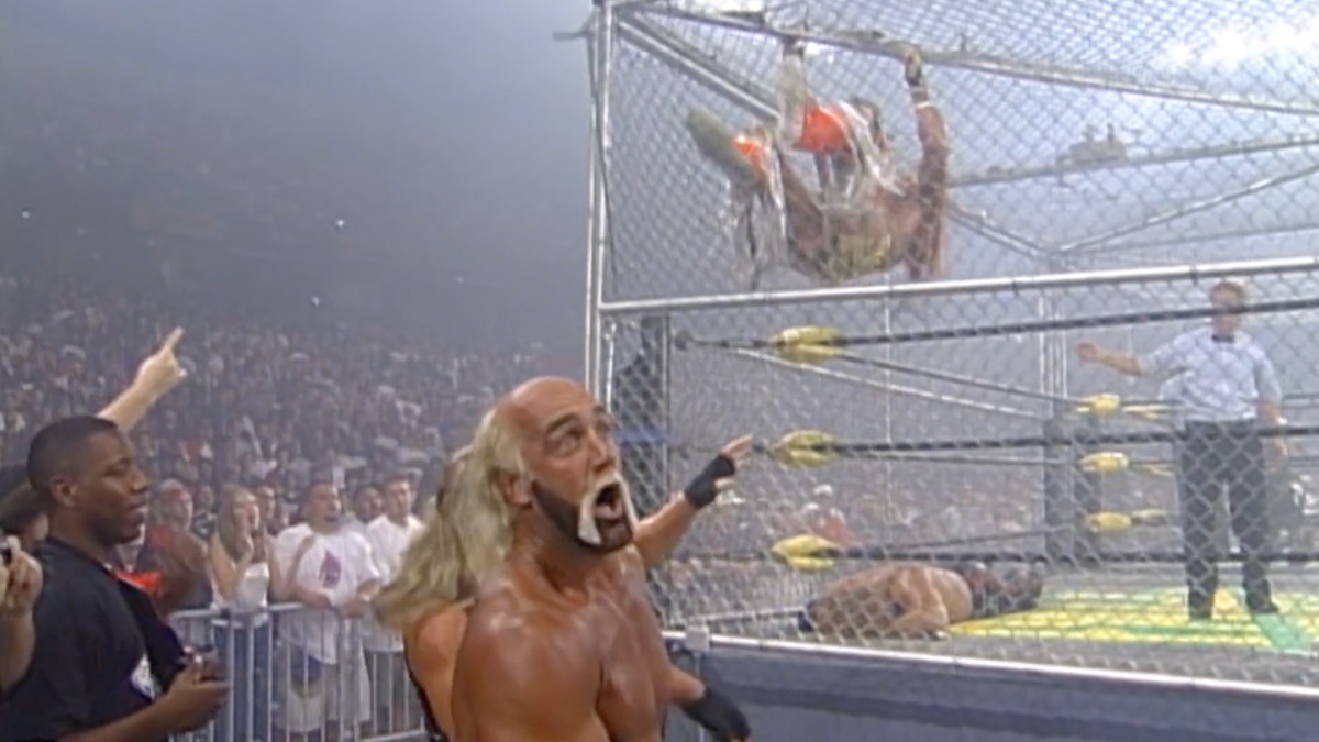 Hulk Hogan looking scared as The Ultimate Warrior kicks his way through the cage 