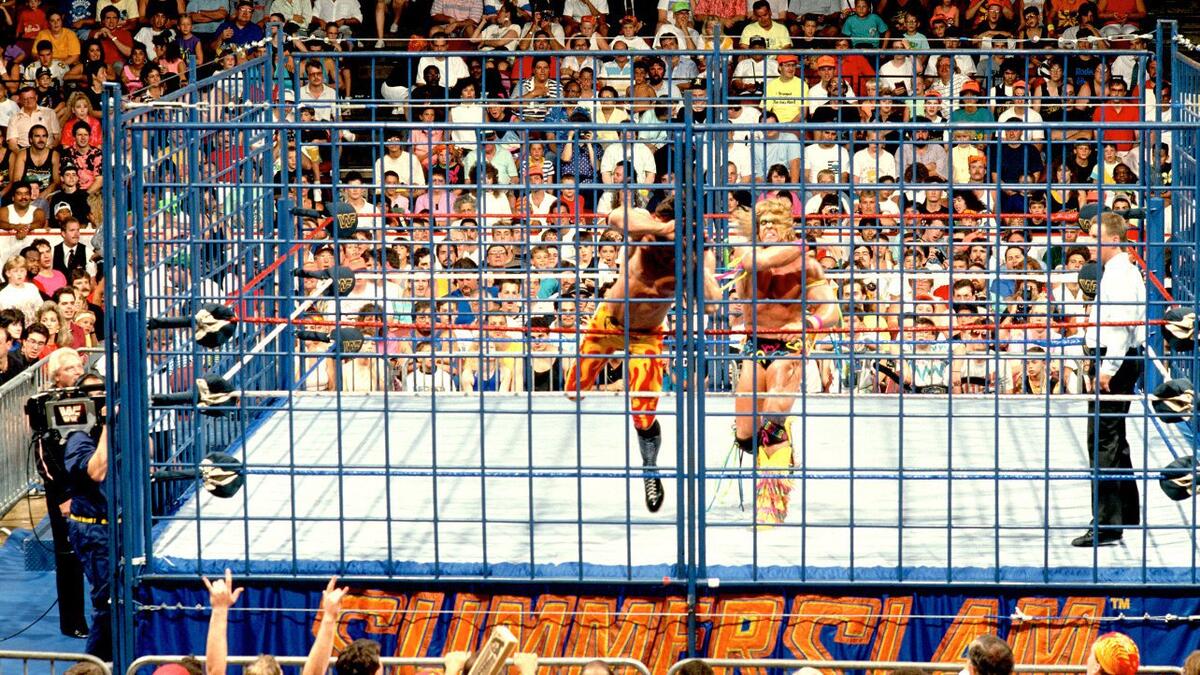 The Ultimate Warrior throws Rick Rude into the cage at WWE SummerSlam 1990